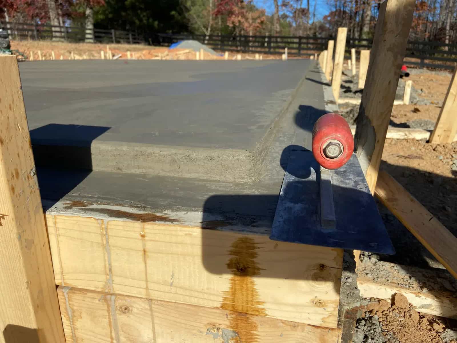 Monolithic foundation edge detail showing notched lip and concrete prep
