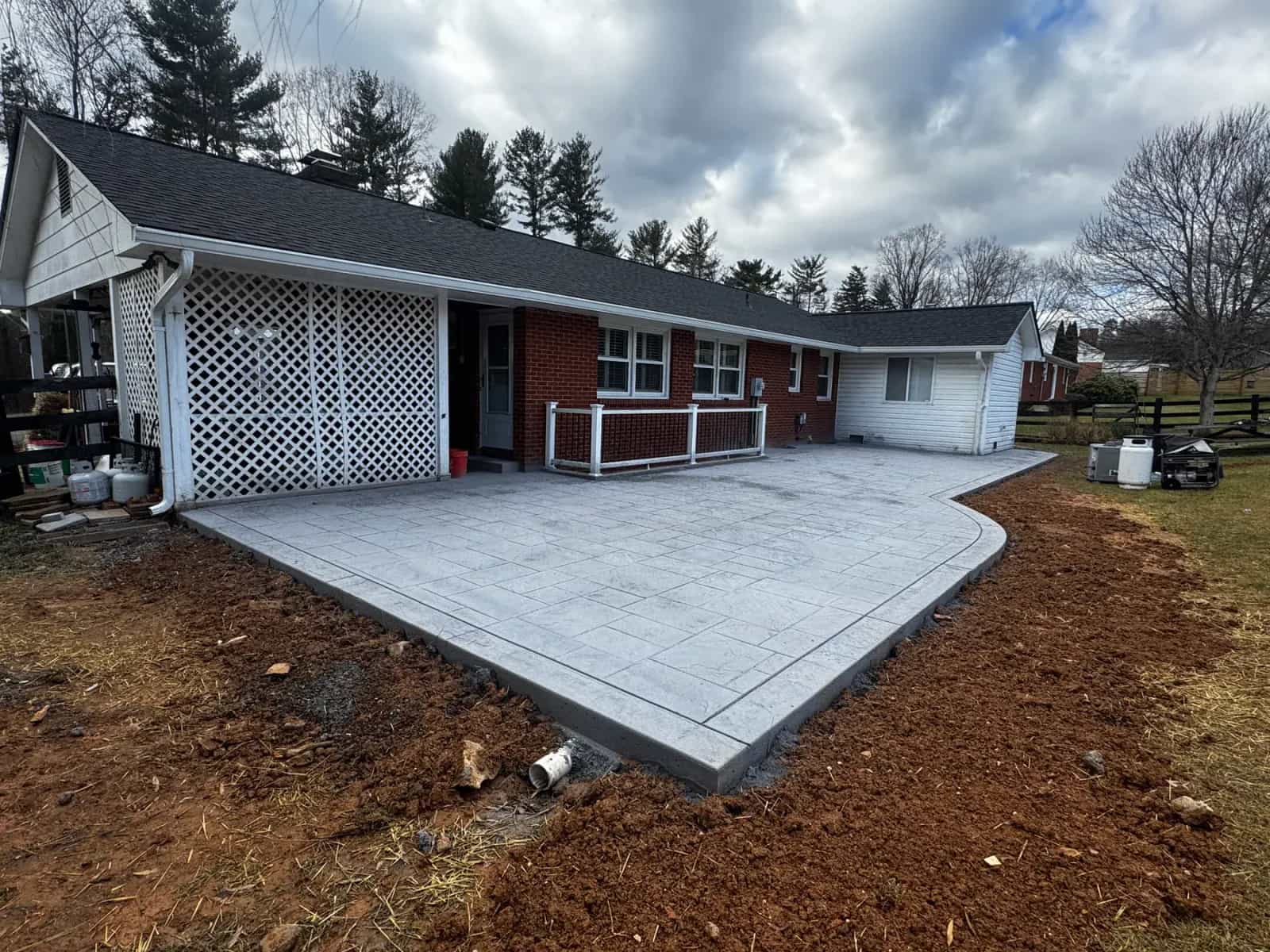 Wide stamped concrete patio with finished decorative surface