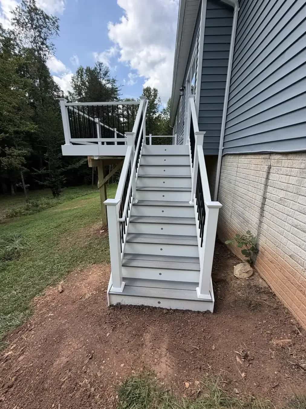 Trex Pebble Beach deck stairs with white railings and black balusters on a Culpeper VA project