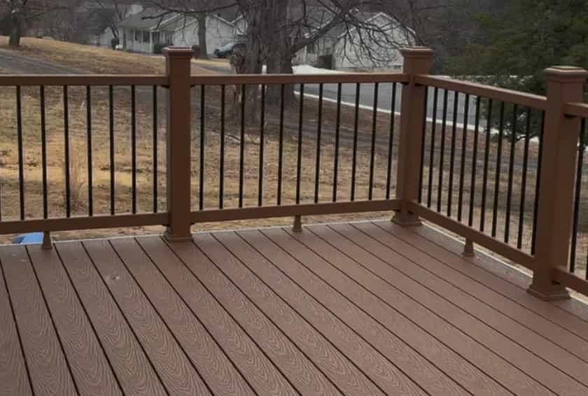 Trex Saddle Brown handrails with black balusters on a Warrenton composite deck