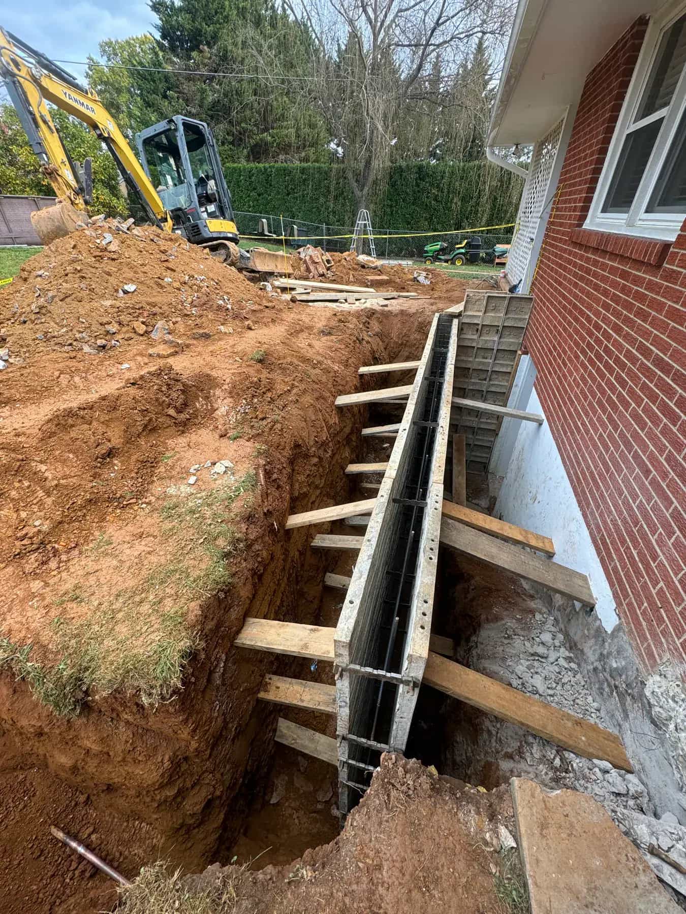 Side view of basement egress stairwell formwork during excavation and concrete prep
