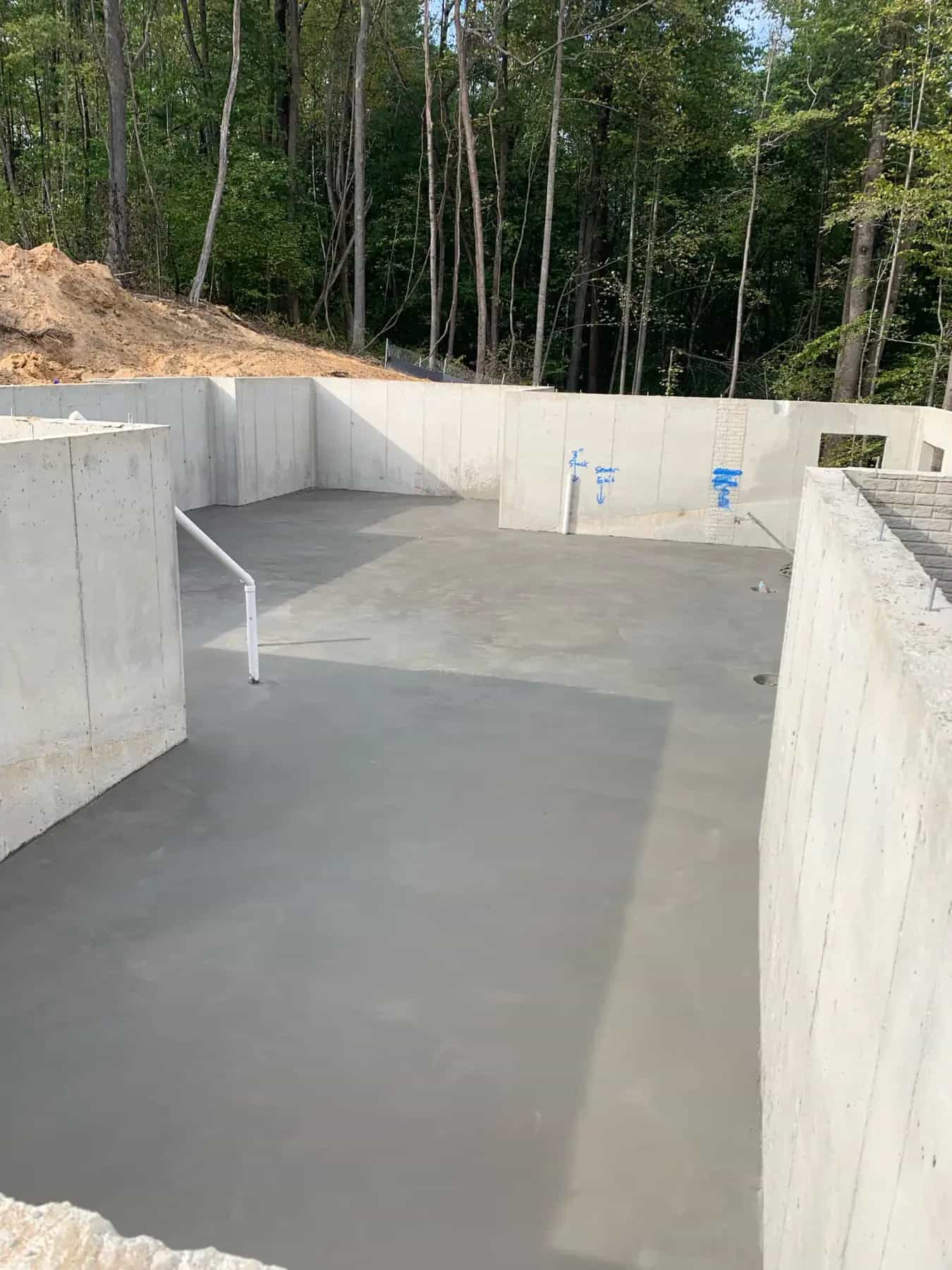 Finished basement slab inside concrete foundation walls
