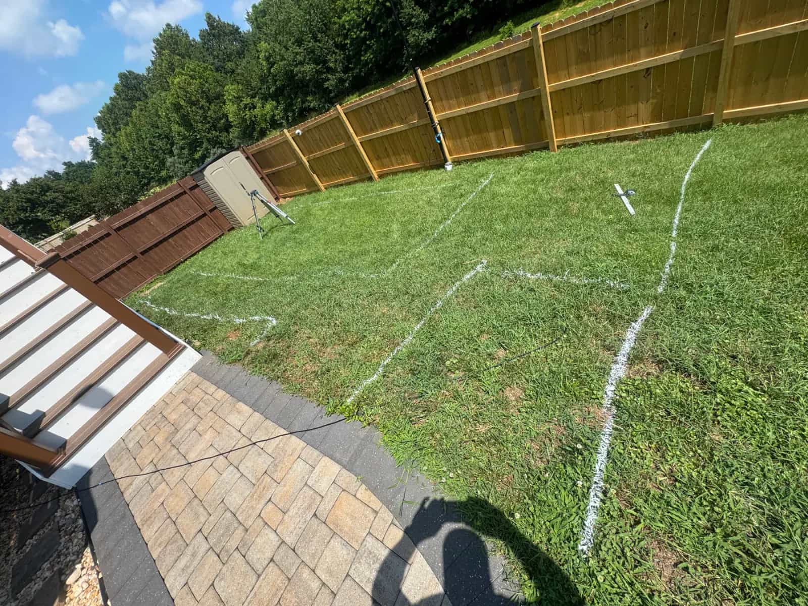 Backyard fiberglass pool layout marking before excavation begins