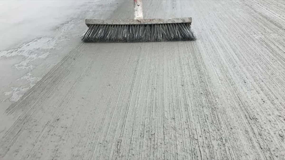Fresh broom-finished concrete surface being finished