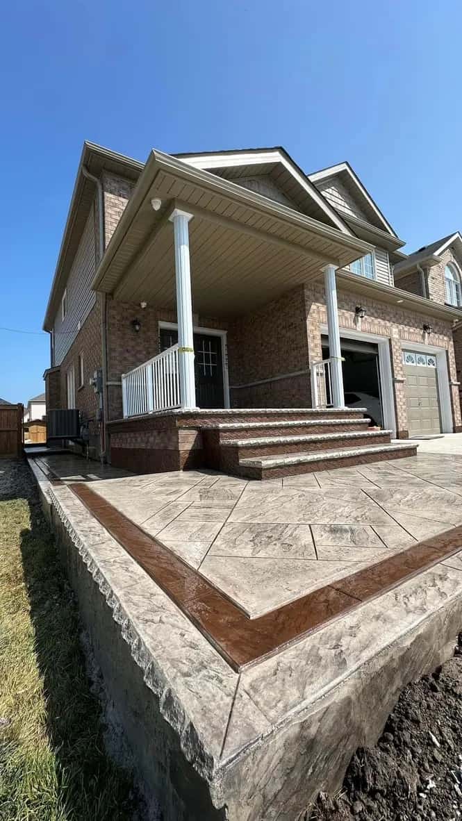 Finished stamped concrete patio with decorative pattern and clean border