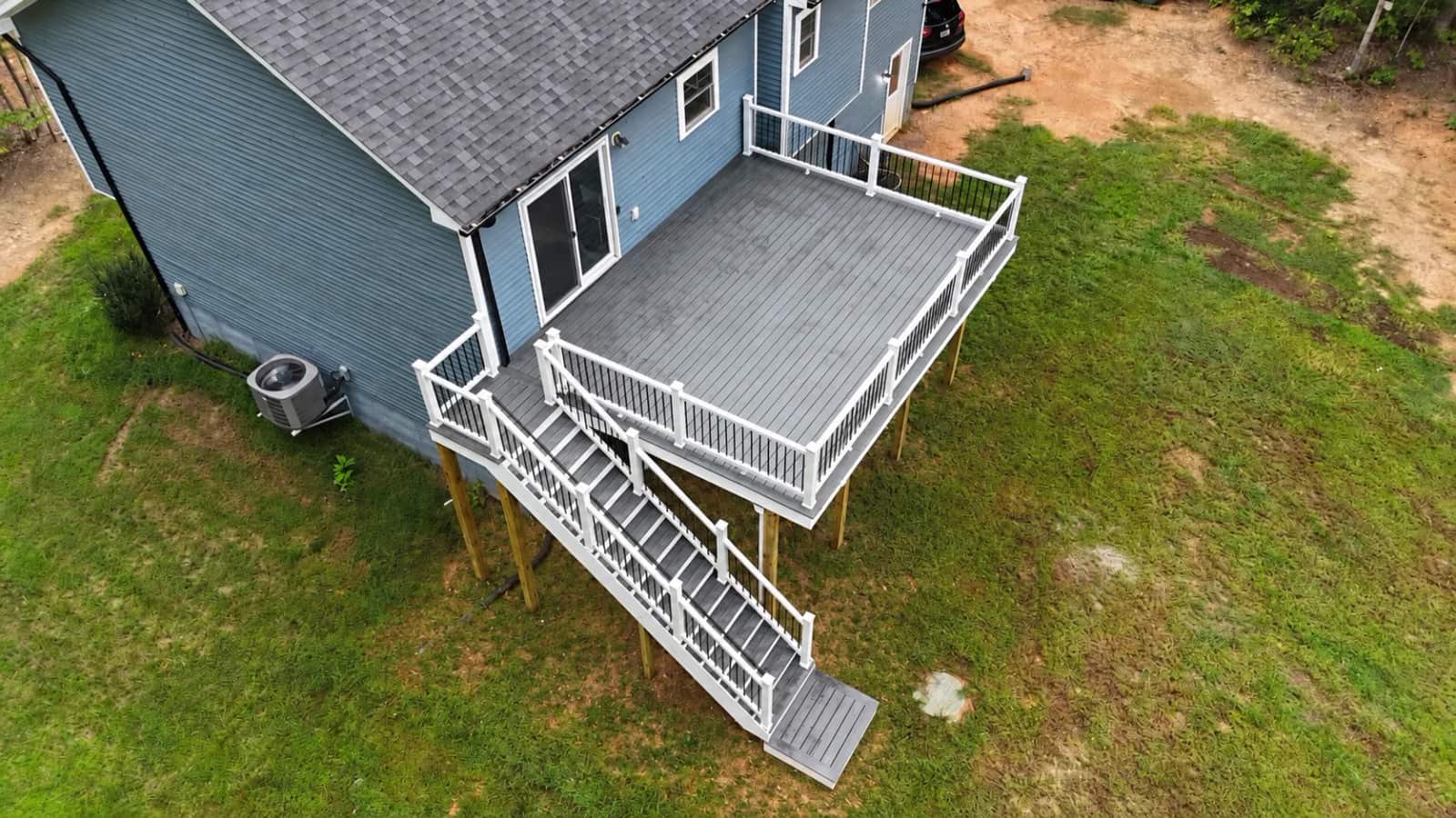 Aerial view of the completed Trex Clamshell deck, white railings and stairs in Fredericksburg VA