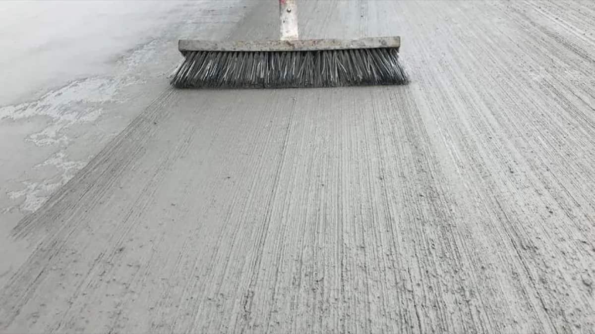 Fresh broom-finished concrete surface being finished