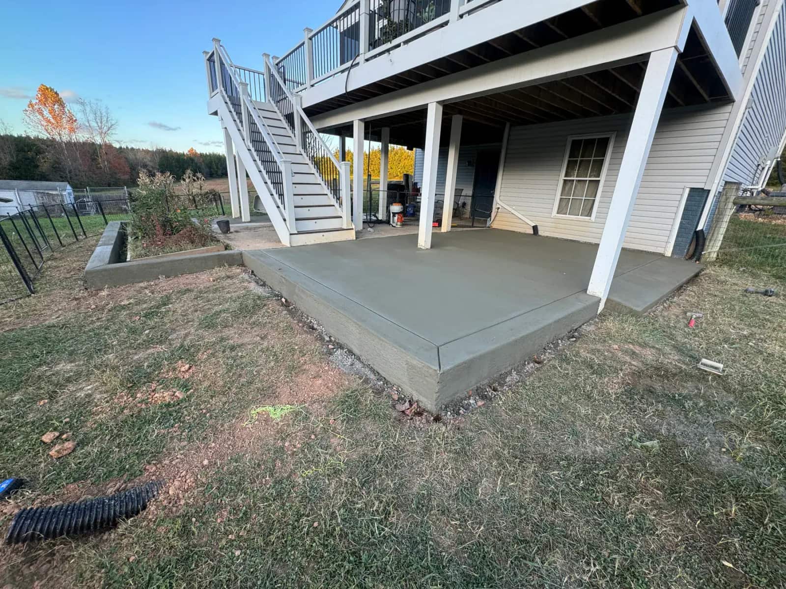 Elevated Battlefield Services deck with concrete outdoor living space underneath