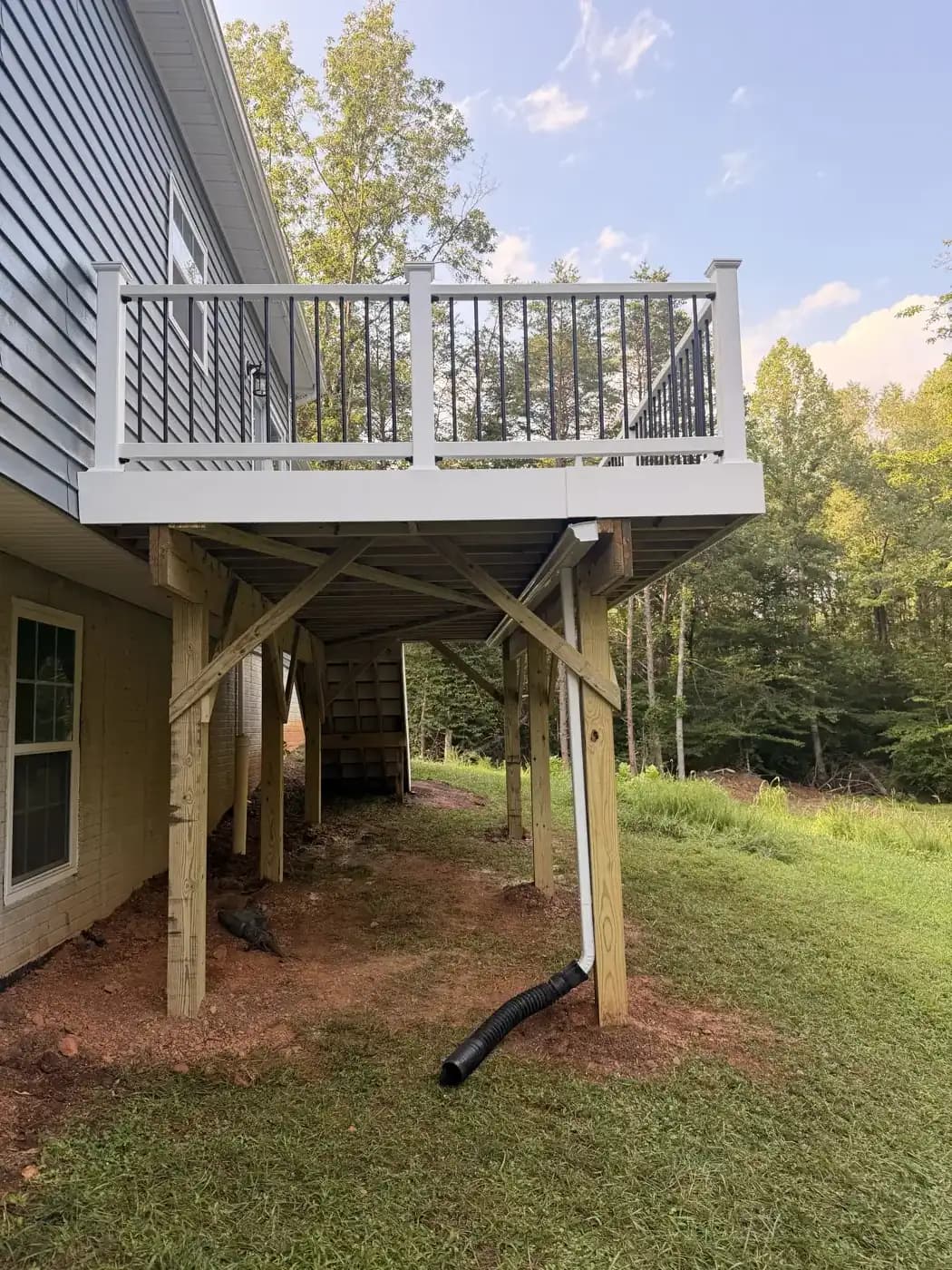 Elevated 10x20 Trex Pebble Beach deck with RainGuard protection below in Culpeper VA