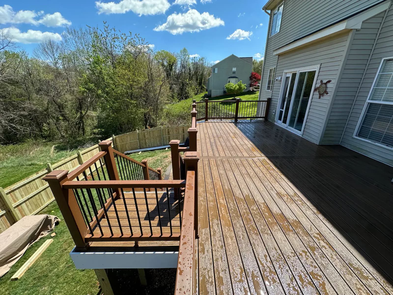 Elevated wood deck side view with stairs and support framing