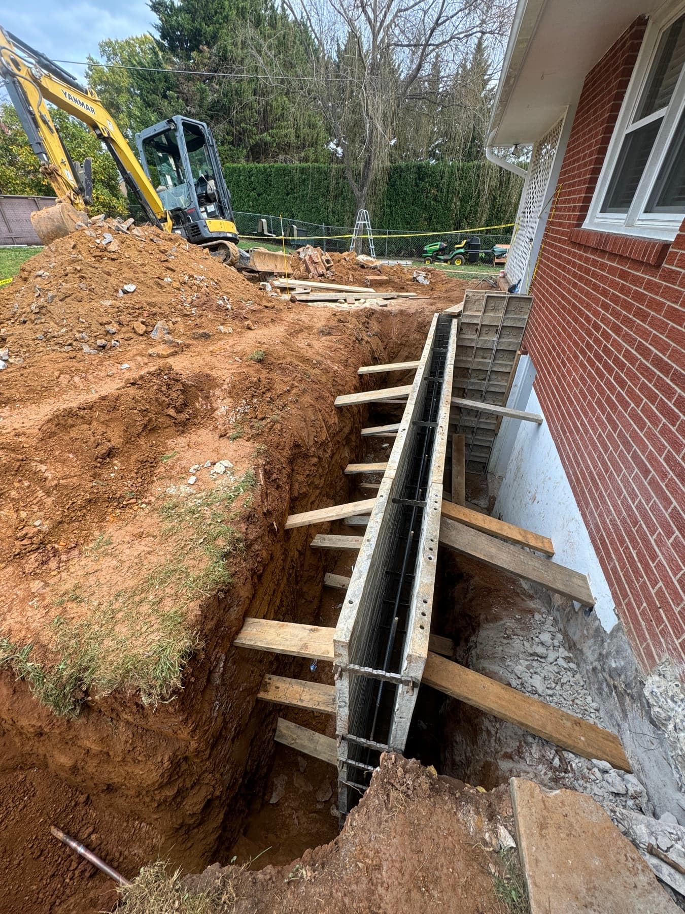 Side view of basement egress stairwell formwork during excavation and concrete prep