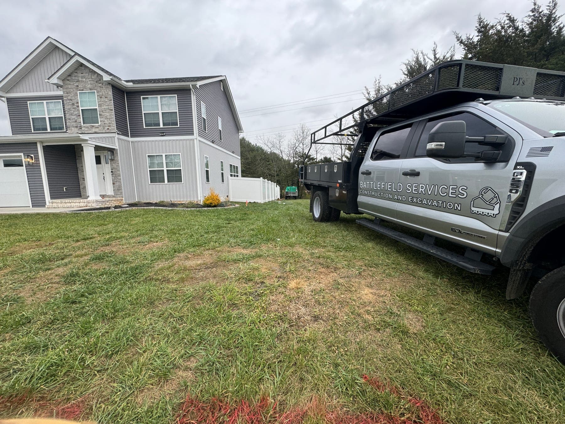 Battlefield Services truck parked at a fence installation project