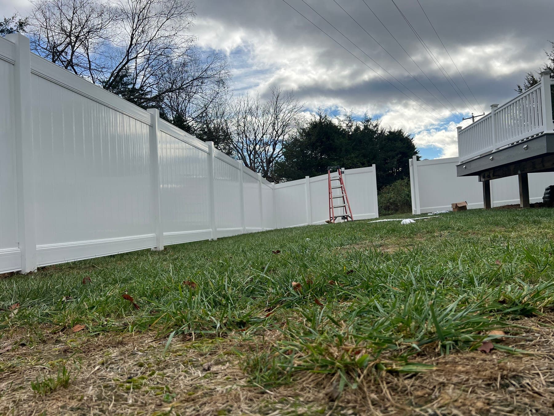 White vinyl privacy fence installed around a Culpeper backyard