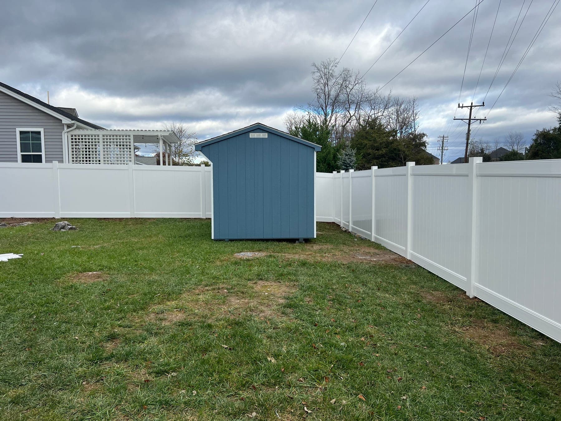 White vinyl privacy fence installed around a Culpeper backyard