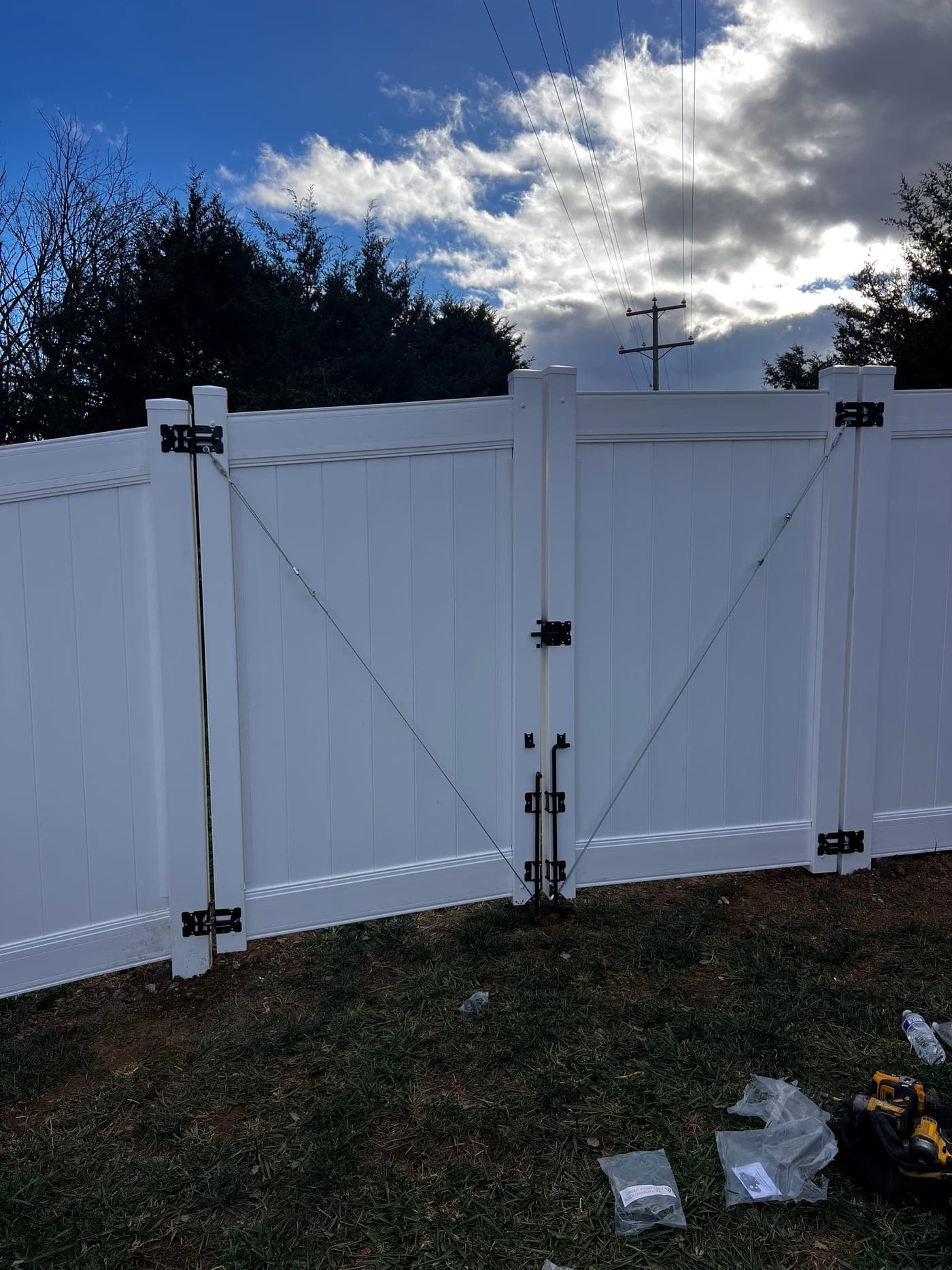 White vinyl double gate with hardware and bracing detail