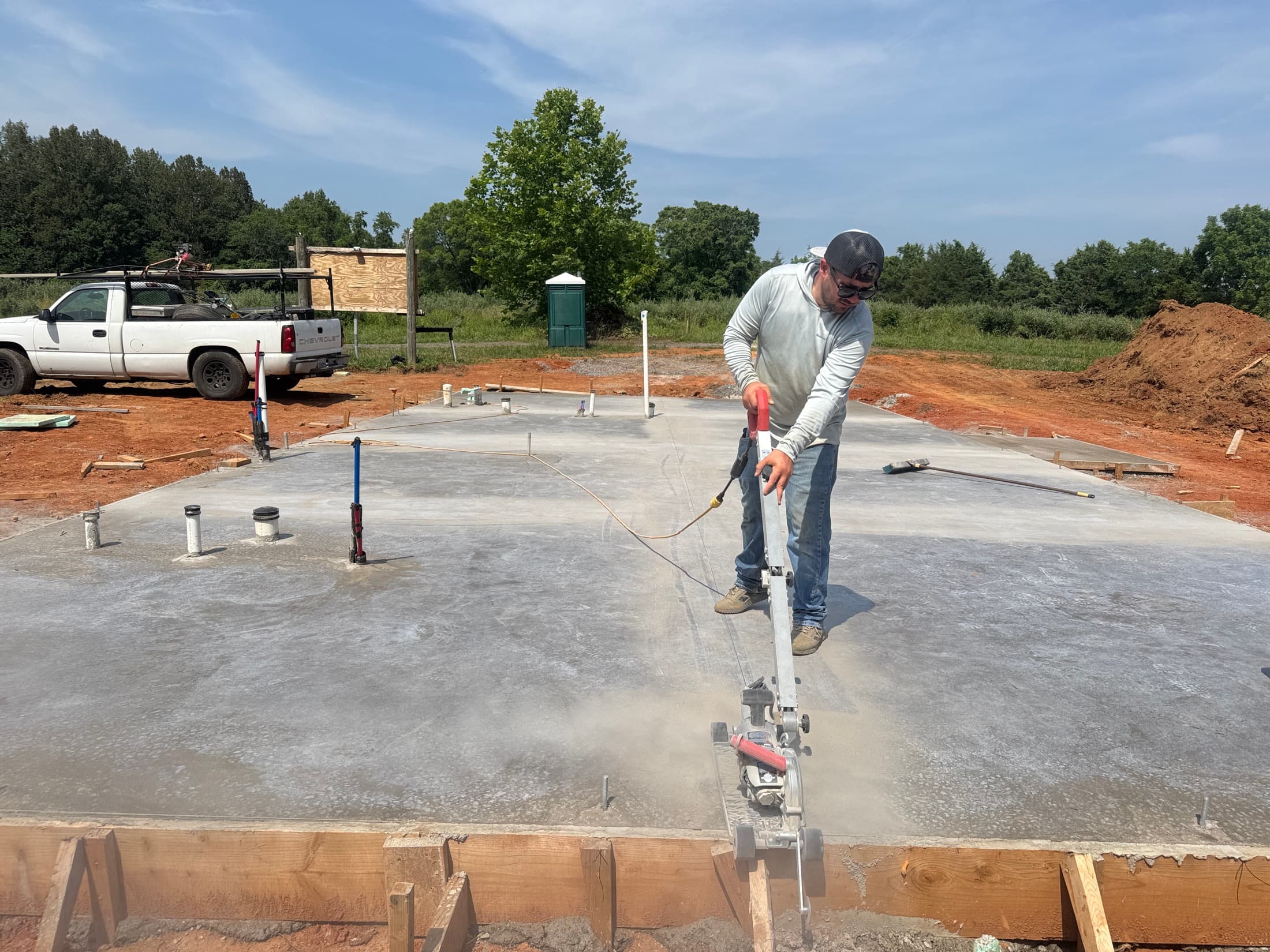 Concrete slab being finished with power trowel equipment