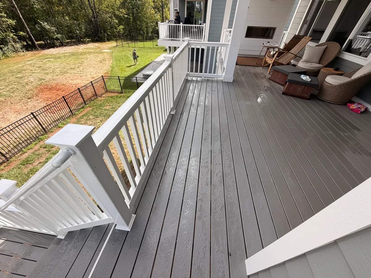 Finished detail: the stair connection beside the covered deck and outdoor seating
