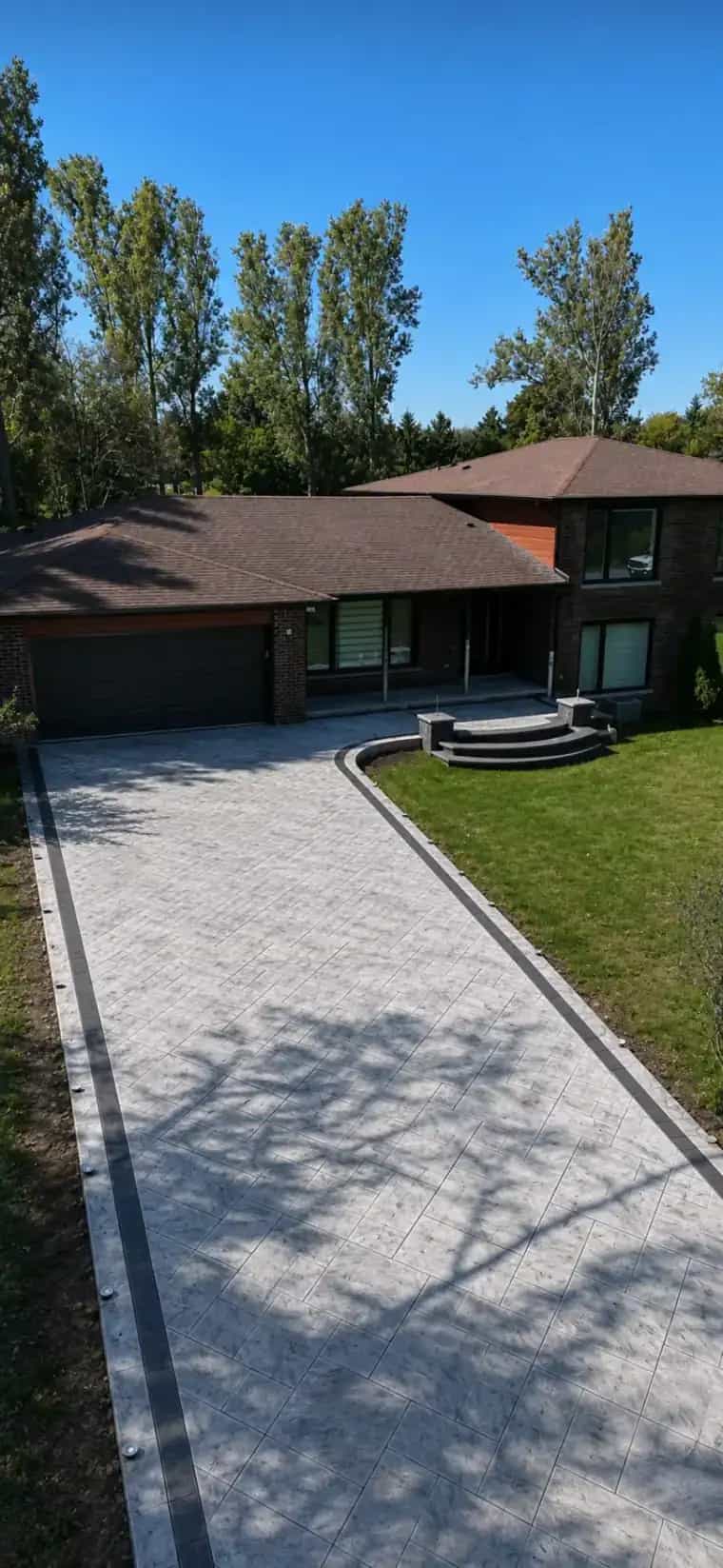 Finished stamped concrete driveway in Culpeper VA with a clean border and large driveway surface