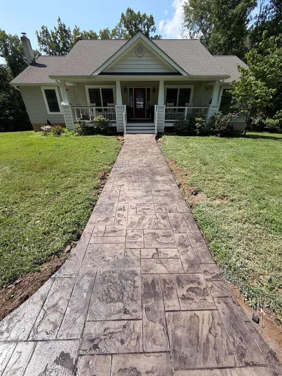 Finished stamped concrete sidewalk leading through the lawn to a front porch in Culpeper VA