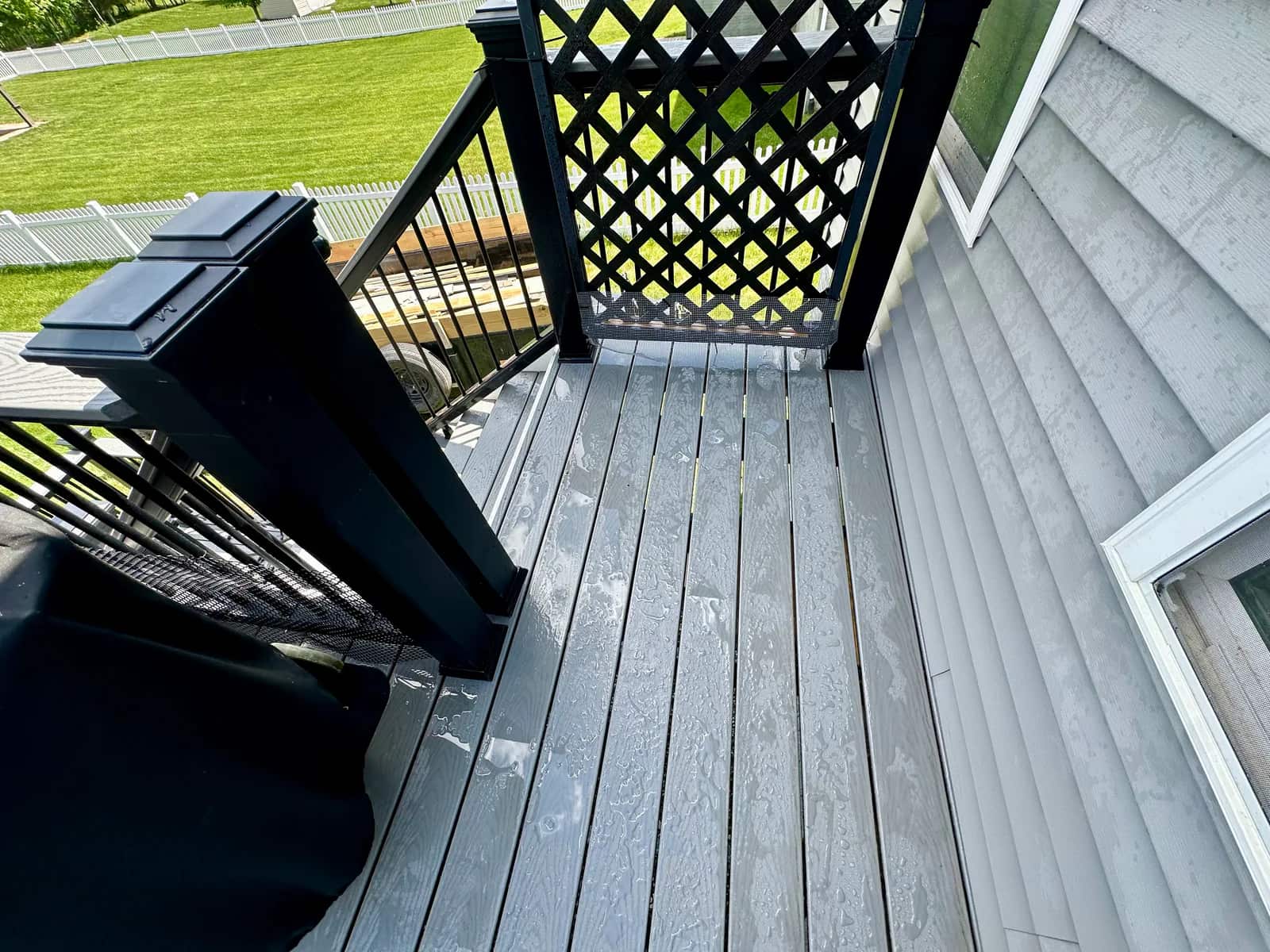 Trex Pebble Grey deck resurfacing detail at doorway and retained railing in Orange Virginia