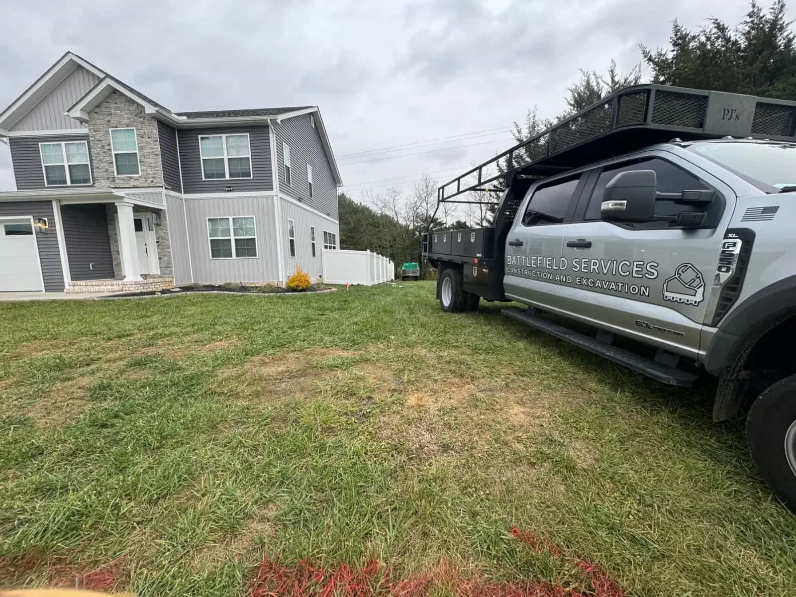 Battlefield Services truck parked at a fence installation project
