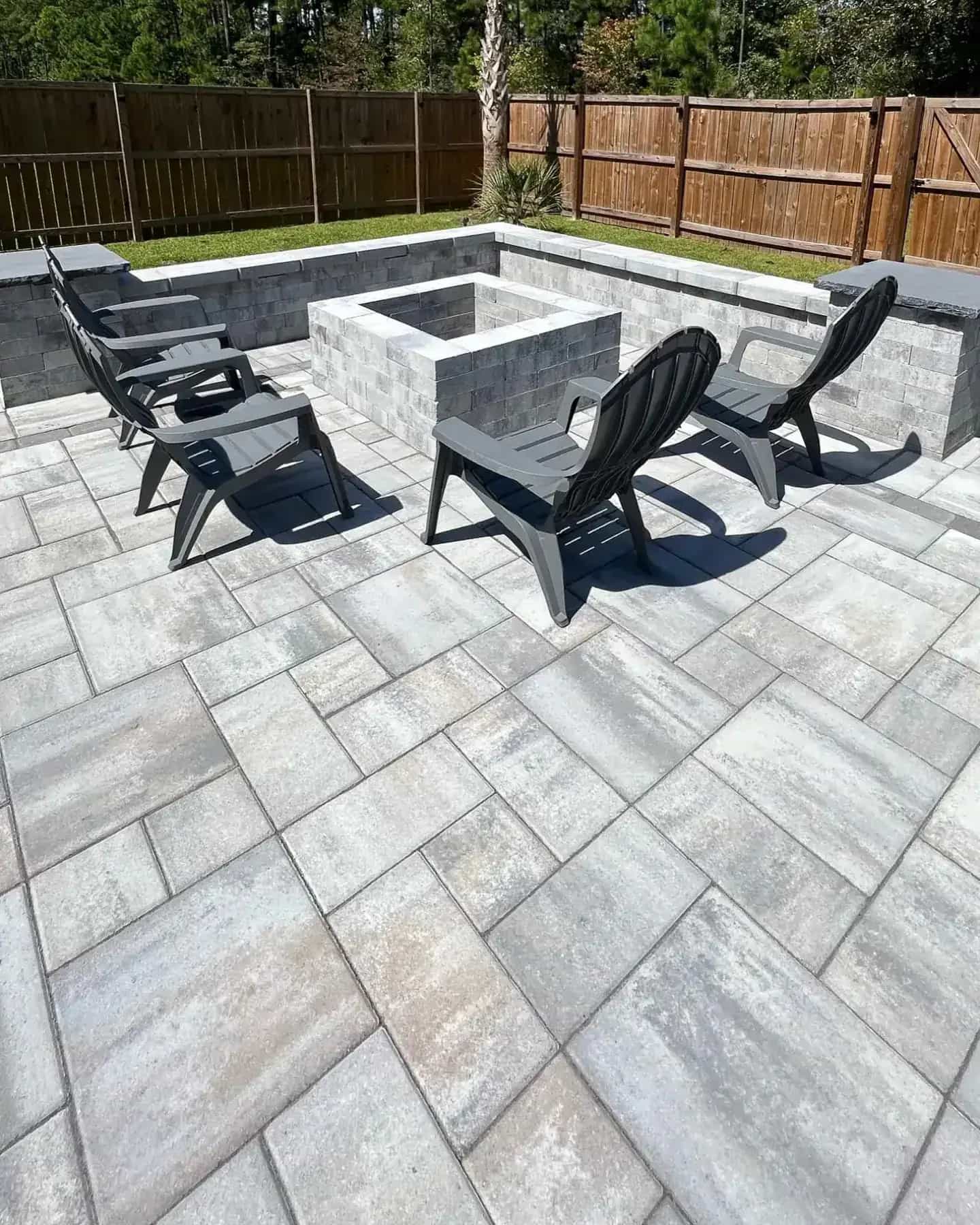 Finished paver patio with fire pit seating area and outdoor living hardscape