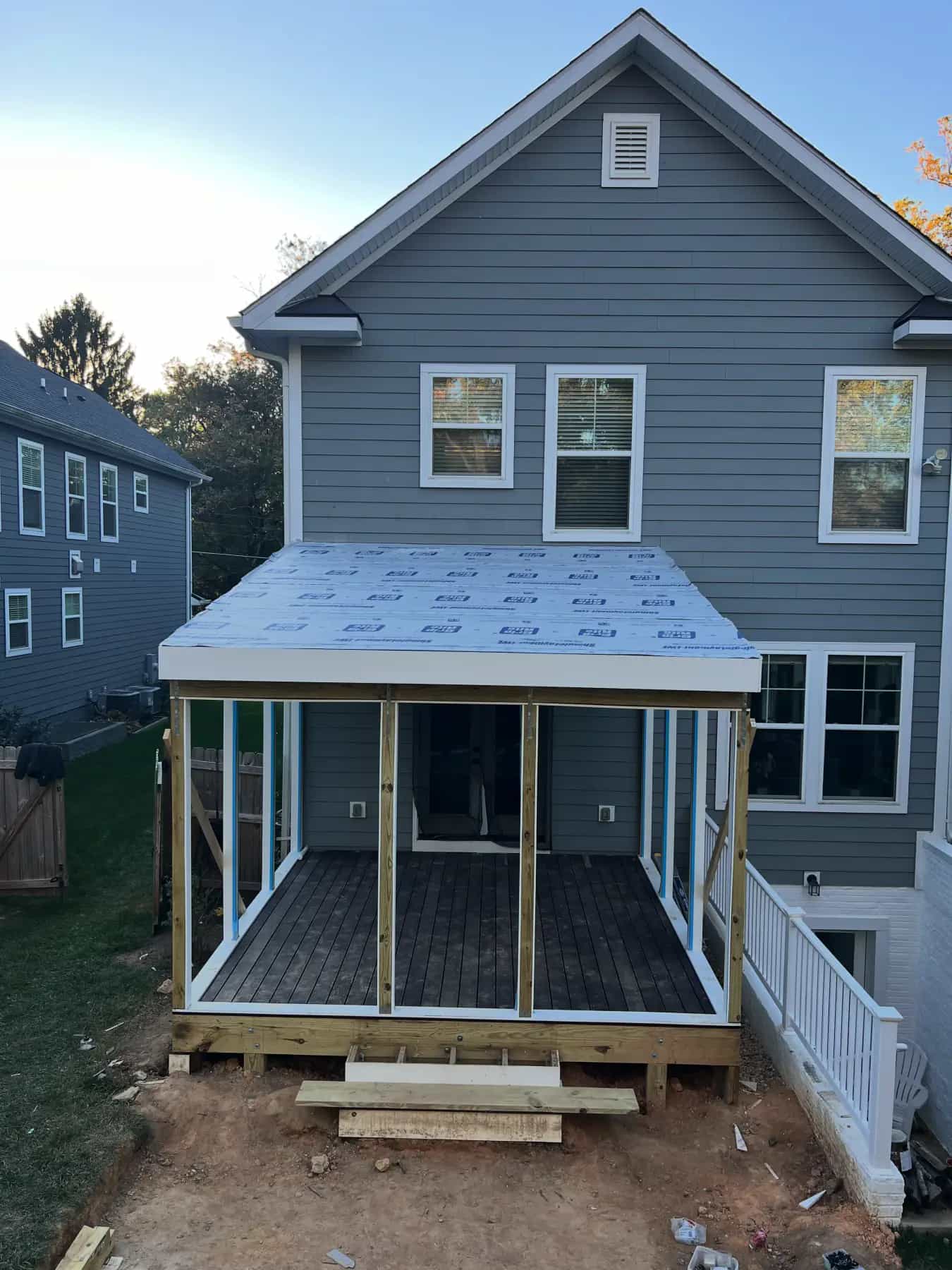 Screened porch framing and roof structure under construction